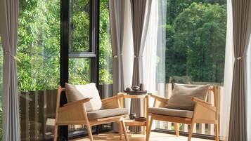 Superior Suite, Hill View | Living area | 65-inch TV with cable channels, pay movies