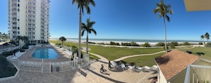 A hotel with a swimming pool, beach view, and palm trees. - Direct Ocean & Pool Views, Fully Updated 1-BD Condo on FMB. 105A (Fort Myers Beach)