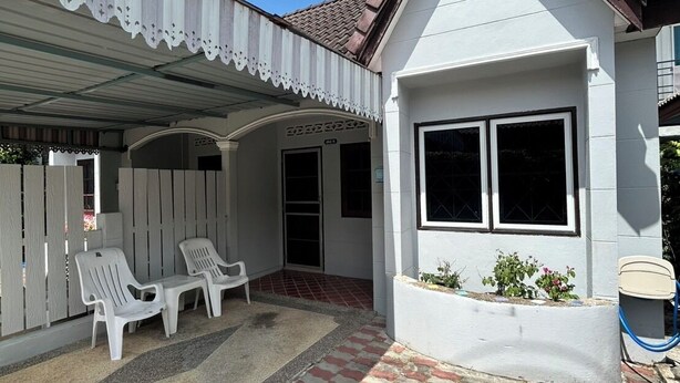 A house with a covered patio area, a small garden, and a tiled walkway. - The Endless Bangtao Residence: PM1 (Thalang)