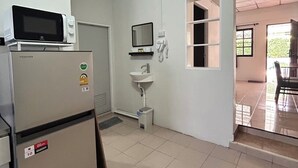A compact kitchen with a refrigerator, microwave, and sink. - The Endless Bangtao Residence: PM1 (Thalang)