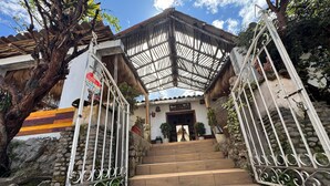A set of stone steps leading to a building with a metal gate. - SUMAQ QUINUA (Carmen Alto)