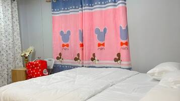 A bedroom with a bed, a nightstand, a red bag, and a wall-mounted air conditioner.