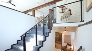 A staircase with a modern design, leading to a second floor.