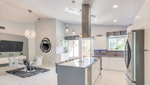 A modern kitchen with a central island, stainless steel appliances, and pendant lighting. - 12 Mi to the Strip: Las Vegas Home w/ Luxe Oasis! (Las Vegas)