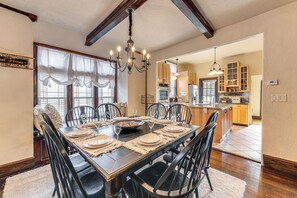Enjoy meals with family and friends in this inviting dining area, featuring a large table and comfortable chairs.