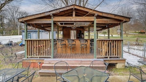 A wooden gazebo with a covered patio, metal chairs, and tables. - 6 Mi to Downtown: 70s-Themed Home in Nashville! (Nashville)