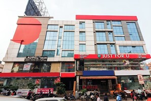 A multi-story commercial building with various storefronts, including a salon, a baby care store, and a toy store. - Hotel Diamond Park, Madhapur (Hyderabad)
