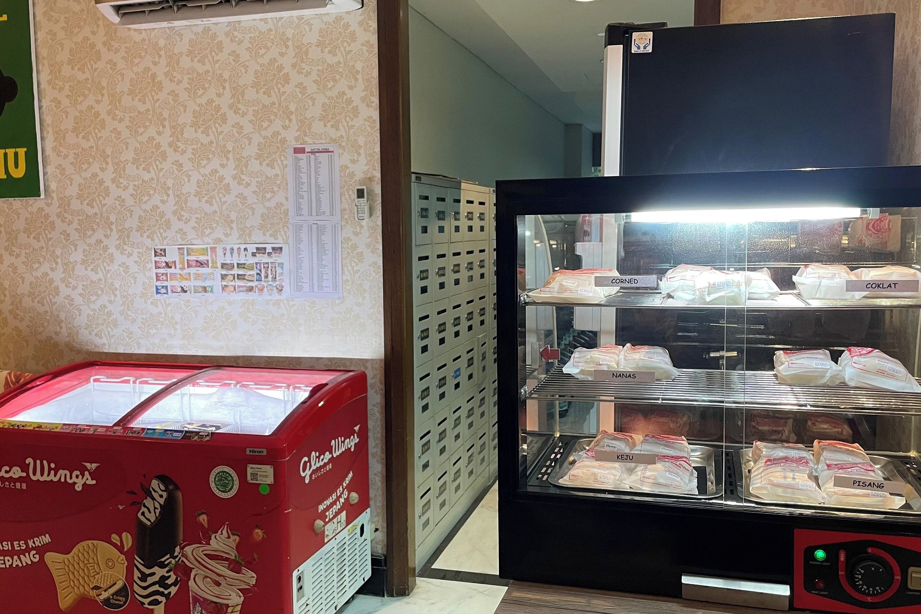 A vending machine with various food items and a display case with packaged goods.