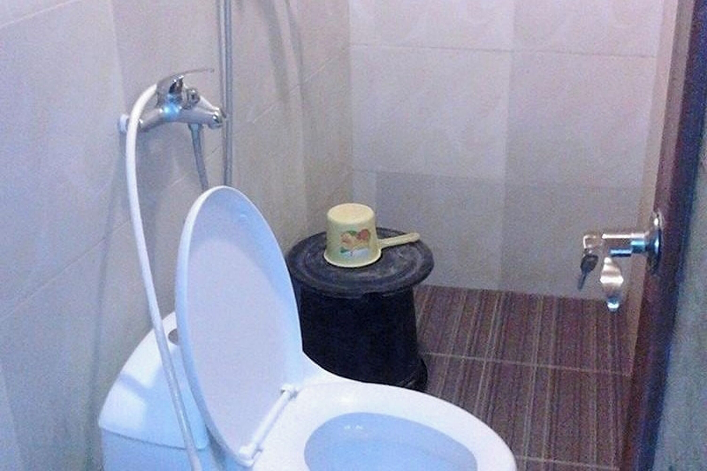 A bathroom with a toilet, a bidet, and a small trash bin.