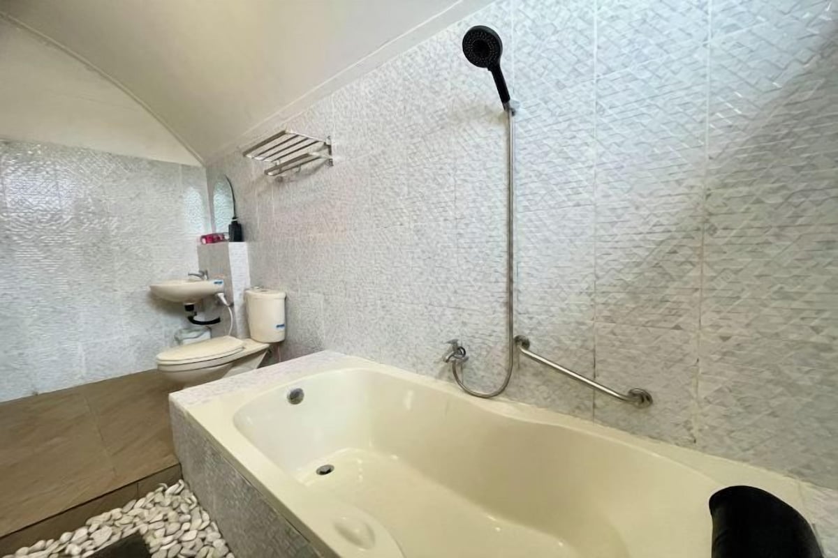 A bathroom with a bathtub, a shower, and a toilet.