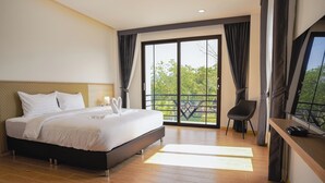 A modern hotel room with a large bed, a desk, and a balcony with a view. - Daoneua Riverside Resort (Muang Fuang)