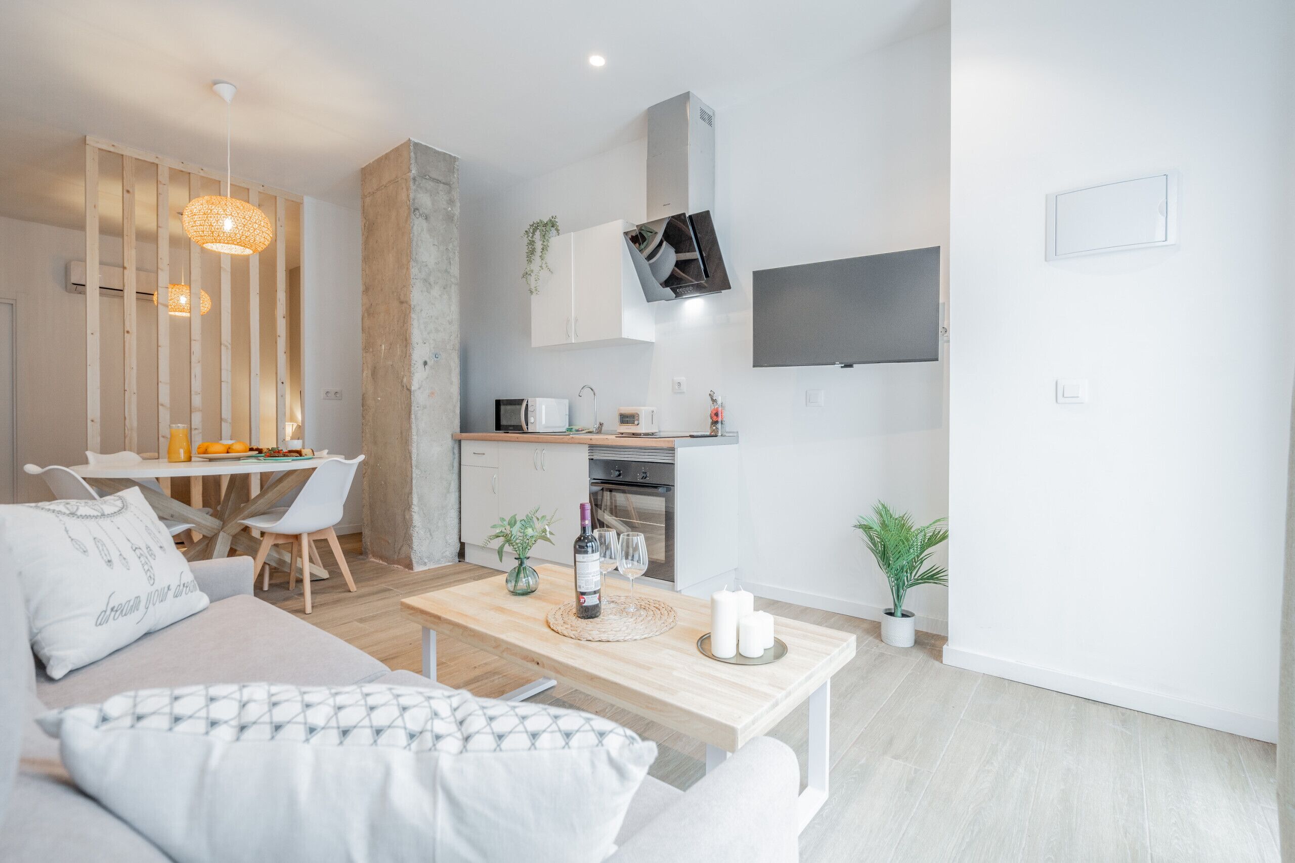 Eine moderne Küche mit Mikrowelle, Backofen und einem an der Wand befestigten Fernseher.