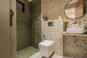 A modern bathroom with a shower, toilet, and sink. - ELIVAAS Kamerios Verano 1 BHK with Pool (Marra)