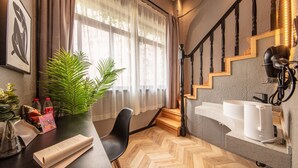 A modern hotel room with a wooden herringbone floor, a staircase with wooden steps and black balusters, a white sink, and a large window with sheer curtains. - Iforest Hongkou Football Stadium (Shanghai)