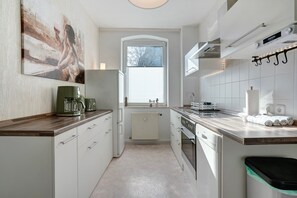 Fridge, stovetop, dishwasher, coffee/tea maker