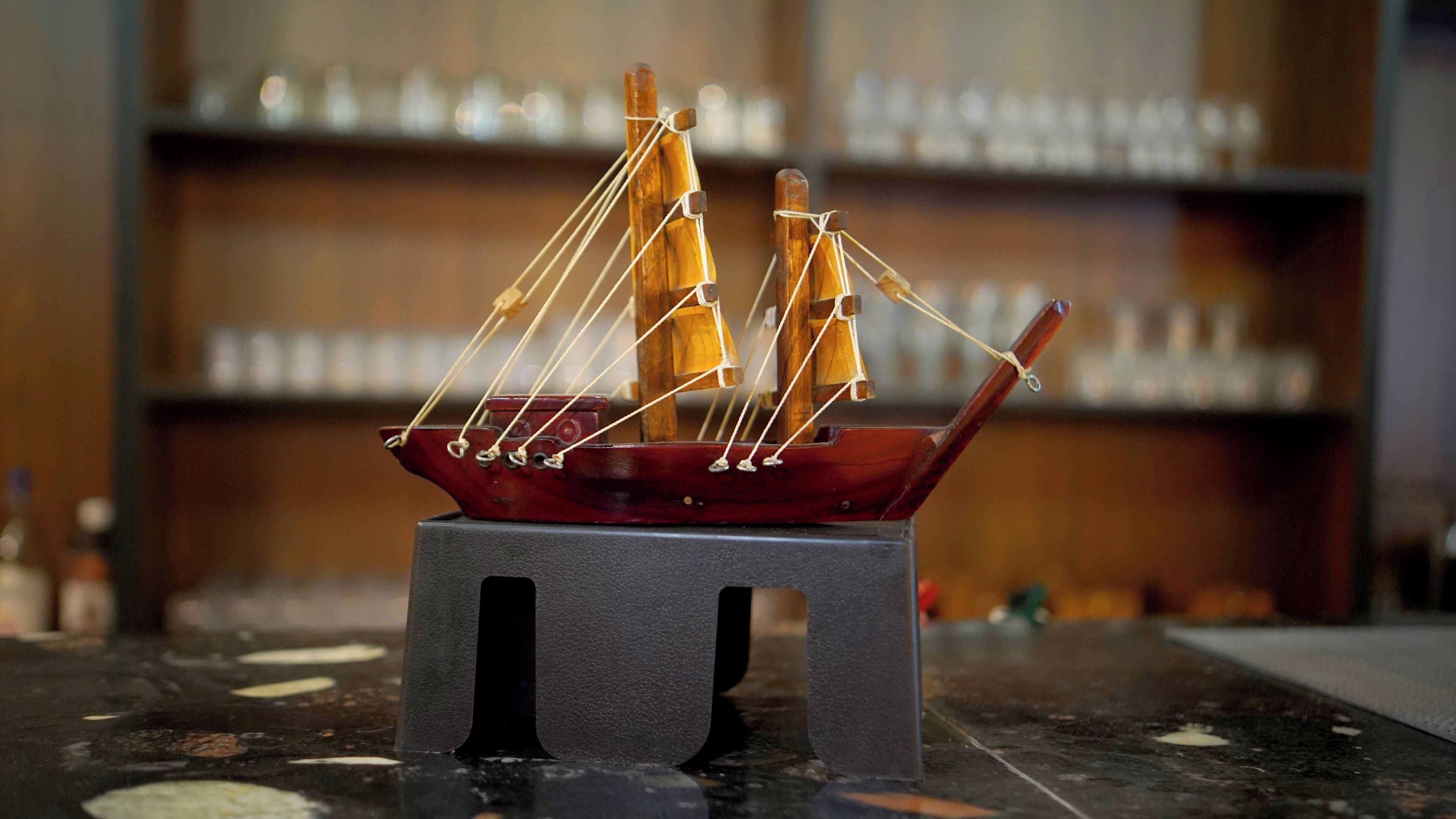 A model ship on a small stool.