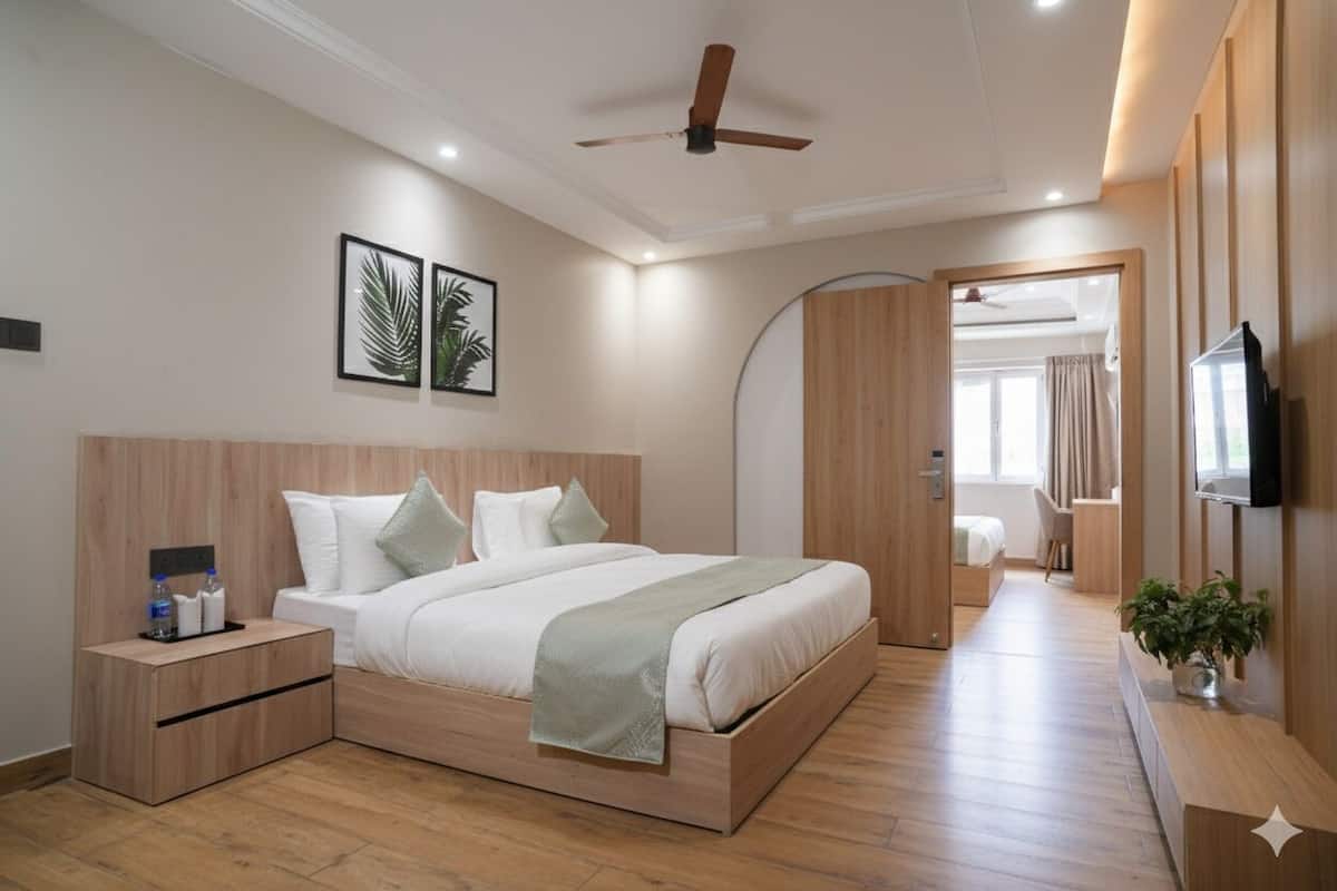 A modern bedroom with a wooden bed, bedside tables, a ceiling fan, and a TV.