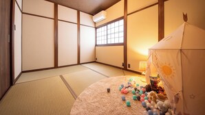 A traditional Japanese room with tatami flooring, shoji screens, and a tatami mat in the center. - Nara-no-ya (Nara)