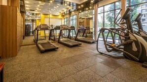 A gym with treadmills, elliptical machines, and weight machines. - Vinhomes Ocean Park Apartment FL09 (Hanoi)