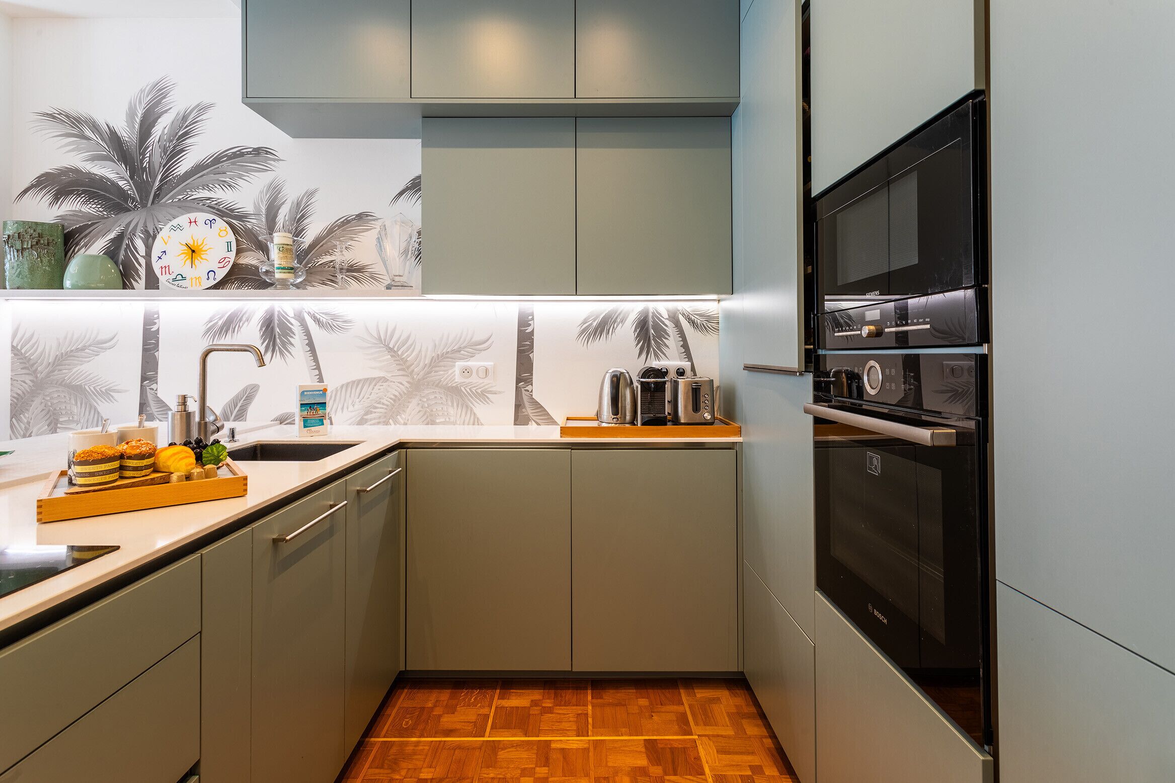 A compact kitchen with a built-in oven, a microwave, and a coffee maker.