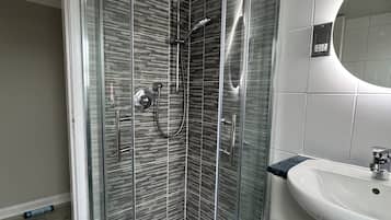 Shower, hair dryer, towels, toilet paper