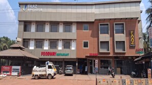 A multi-story building with a FAACZ International sign, a FOODWAY restaurant, and a ROOMS sign. - Hotel Faaz International (Kannur)