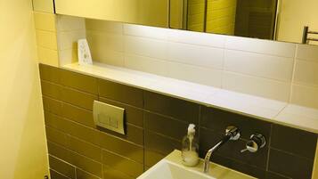 Shower, hair dryer, towels, toilet paper