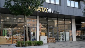 A modern building with large glass windows and a sign reading "ATAMarket". - Lovely Family Suite (Apart534), Lovely family suite: luxurious modern apartment with private garden (Prague)