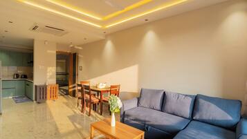 Apartment, 1 King Bed, Balcony, City View | Living area | Flat-screen TV