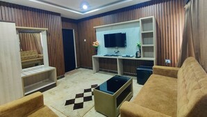 Ein modernes Wohnzimmer mit Sofa, Couchtisch, Fernseher und einem kleinen Beistelltisch.