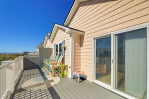 A balcony with a view of the beach, wooden deck, and outdoor furniture. - 2 Blocks to Shore: Atlantic Beach Home w/ Views! (Atlantic Beach)