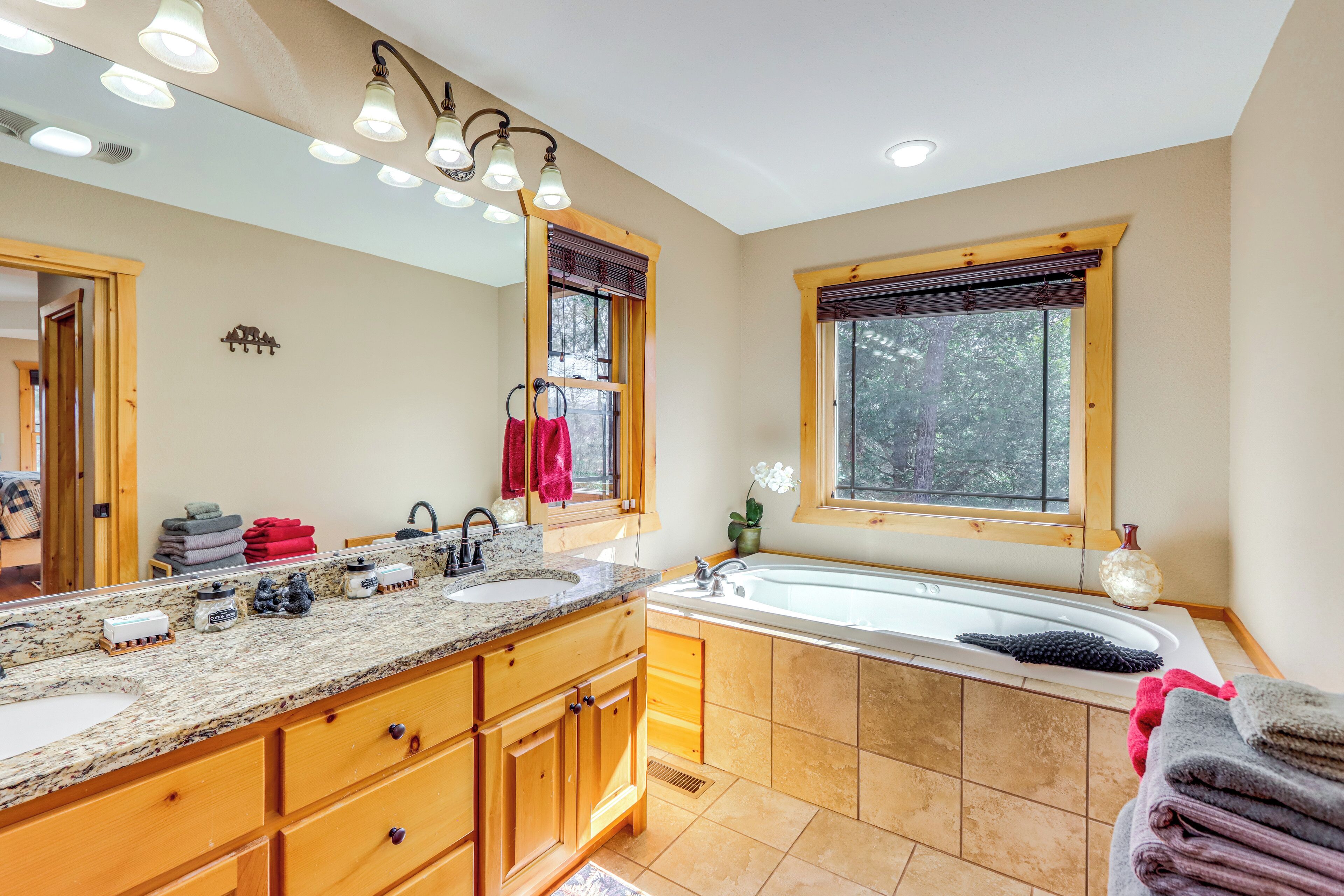 A bathroom with a large vanity, double sink, and a bathtub.