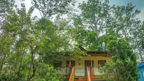 A staircase leading to a building surrounded by lush greenery. - Bon Holong Resort  (Alipurduar)