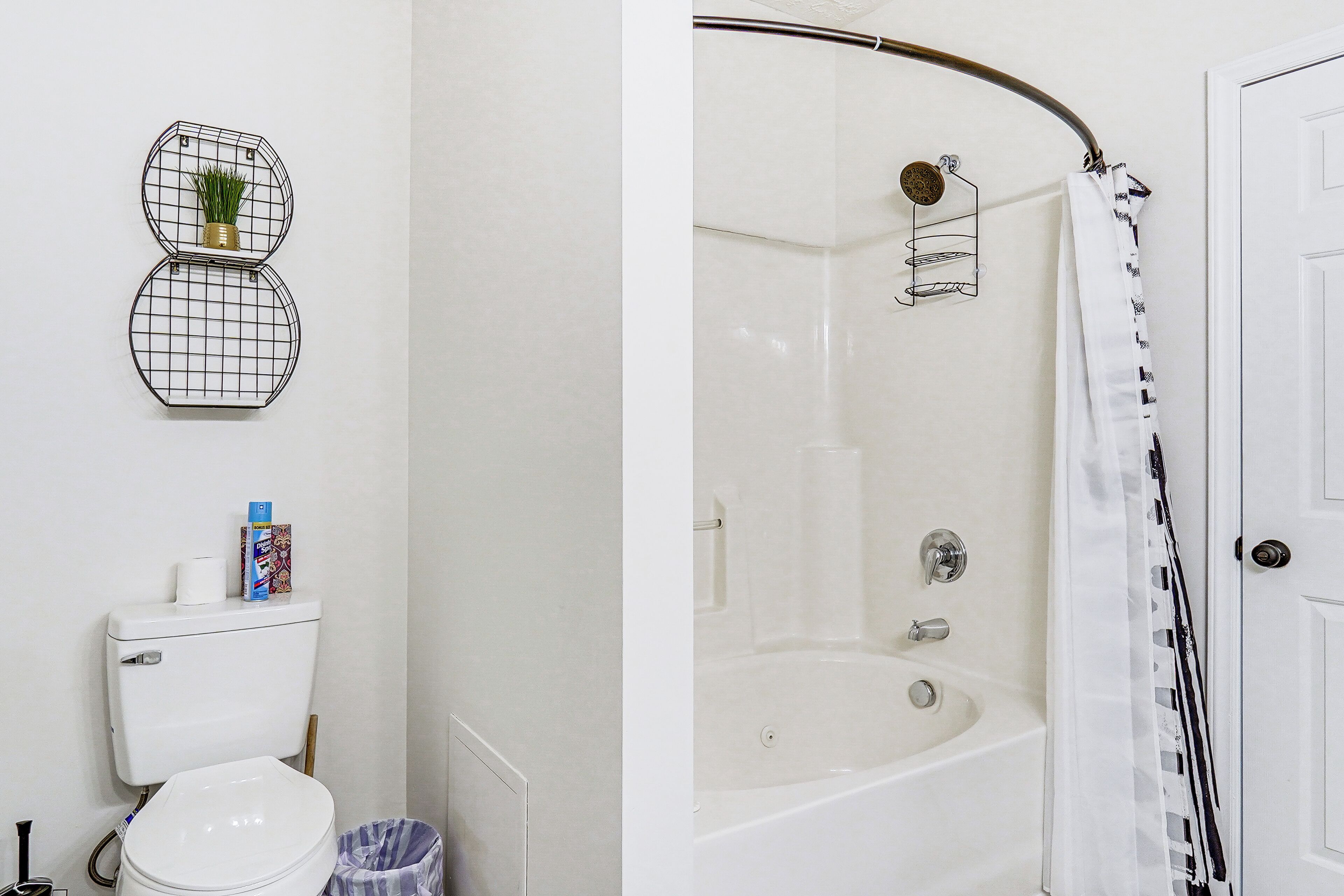A bathroom with a toilet, a shower, and a bathtub.