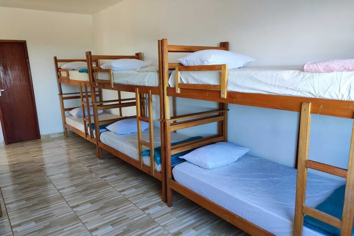 A room with four bunk beds arranged in a row.