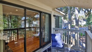 A balcony with a view of a wooden deck and trees. - 34 Forest Gardens: Walk to Beach, Pool, Free Bikes (Hilton Head Island)