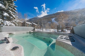 A hot tub with a mountain view, surrounded by snow-covered trees and a clear sky. - 6 Bd, 5 Ba Telluride Condos on the River Trail, Connected, Sleeps 16 (Telluride)