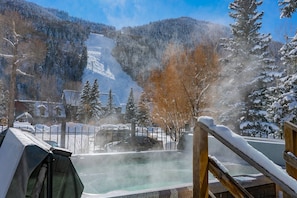 A hot spring area with a wooden deck, surrounded by snow-covered trees and a mountain backdrop. - 6 Bd, 5 Ba Telluride Condos on the River Trail, Connected, Sleeps 16 (Telluride)