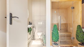 A modern bathroom with a toilet, sink, and shower area. - Jaccuzzi Sauna Private Spa Paris (Montrouge)