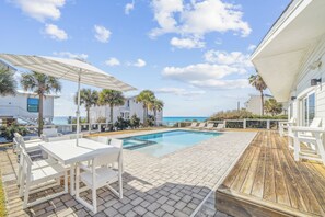 A pool area with white outdoor furniture, a wooden deck, and a view of the ocean. - Private Beach Access, Private Pool/Hot Tub, Beach Service, and Pet Friendly! (Santa Rosa Beach)