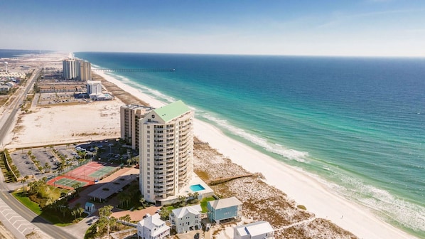 A coastal hotel with multiple buildings, a beach, and a pier extending into the ocean. - Lovely Gulf Front Condo at Belle Mer | Resort Pool | Beautiful Gulf Views (Navarre Beach)