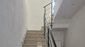 A staircase with a black metal railing leading to a landing. - Pavifè: vacation home in beautiful Avola, pearl of the Ionian Sea (Avola)