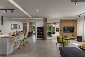 Enjoy meals at the bar counter or dining table for four, with a sofa and chair for relaxation.