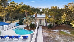 A swimming pool with lounge chairs, a fenced deck, and a house with a door and windows. - Seagrove Beach - Private Pool - Pet Friendly (Santa Rosa Beach)