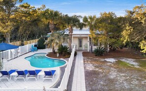 A swimming pool with lounge chairs, a fenced deck, and a house with a door and windows. - Seagrove Beach - Private Pool - Pet Friendly (Santa Rosa Beach)
