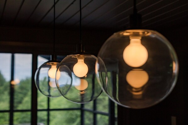 Three spherical glass pendant lights with exposed bulbs hanging from the ceiling.