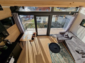 A compact living space with a balcony, a sofa, a dining table, and a kitchen area. - Apartment in Krkonose With Mountain Views (Pec pod Snezkou)