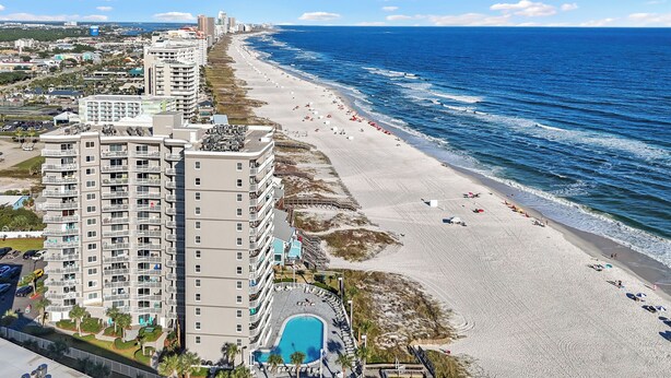 A high-rise hotel with multiple balconies overlooking a beach and ocean. - ☀Sundazed☀ ~ Spectacular Beachside Condo w/Fabulous Pool at Tradewinds in OBA⛱ (Orange Beach)