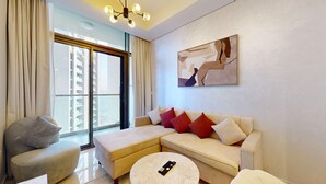 A modern living room with a sofa, armchair, and coffee table. - Calm One Bedroom l Close to Iconic Attractions (Business Bay)