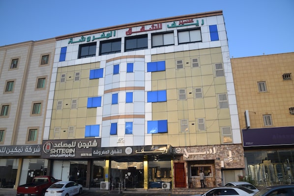 A multi-story building with a mix of commercial and residential units.